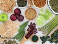 High fiber super foods with whole grain crackers, fruit, vegetables, whole wheat pasta, grains, and nuts
