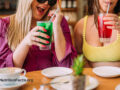 Two people enjoying colorful drinks